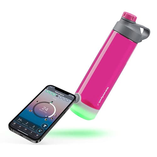 HidrateSpark tap bottle is lying horizontally next to a smartphone